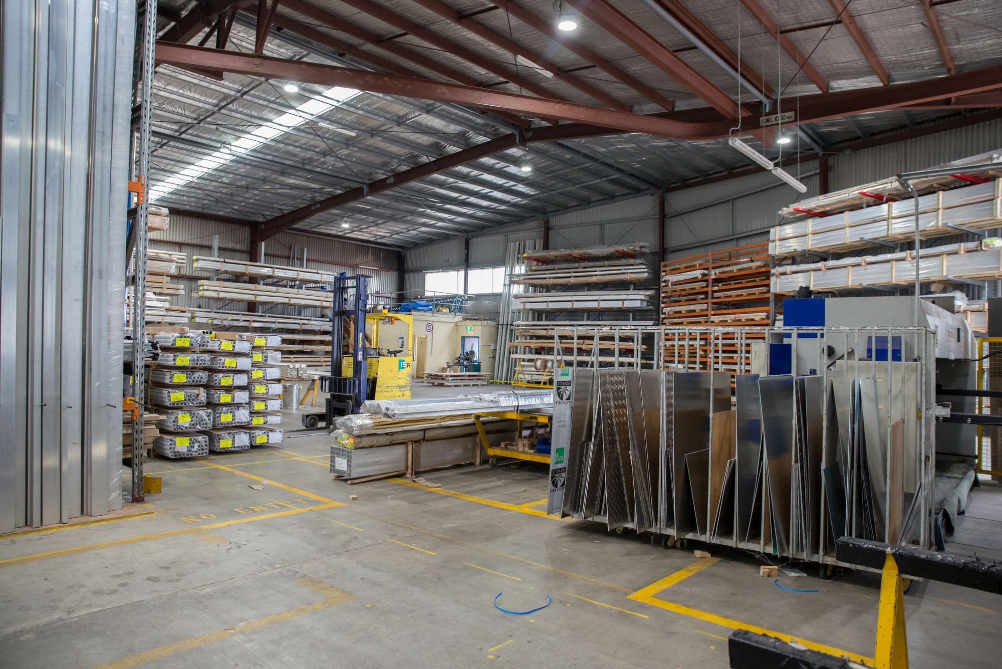 Wide view of an industrial warehouse stacked with steel sections